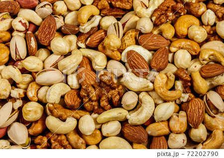 Background of mixed nuts (walnuts, pistachio, almond, peanut, cashew, hazelnut). Healthy eating concept 72202790