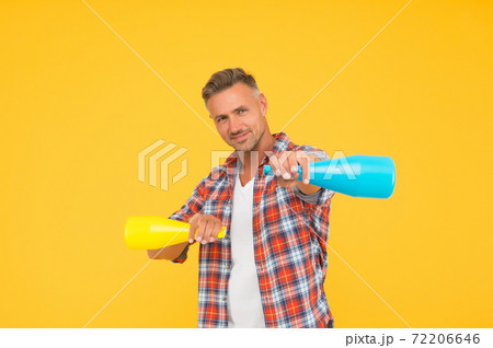 Man spraying disinfectant camera like weapon, cleaning day concept 72206646