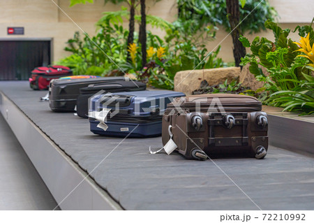 Passenger luggage on conveyor belt at arrival terminal in airport  72210992