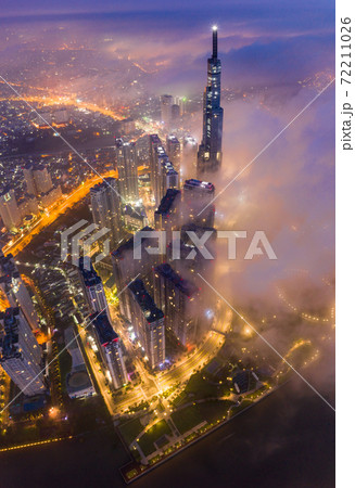 Beautiful aerial night view of cityscape Saigon under foggy sky Beautiful aerial night view of cityscape Saigon under foggy sky 72211026
