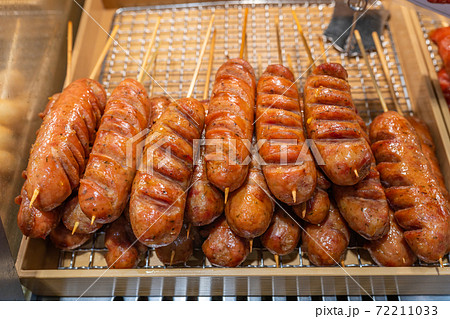 Delicious fried sausage on the rack at food stand Delicious fried sausage on the rack at food stand 72211033