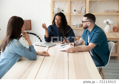 Multiracial businesspeople brainstorm at team meeting in office 72215015