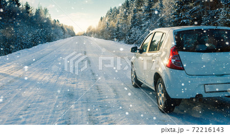 White car on a winter road White car on a winter road 72216143