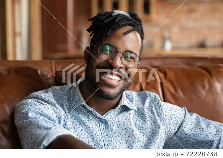 Smiling handsome young african ethnicity man enjoying video call talk. 72220738