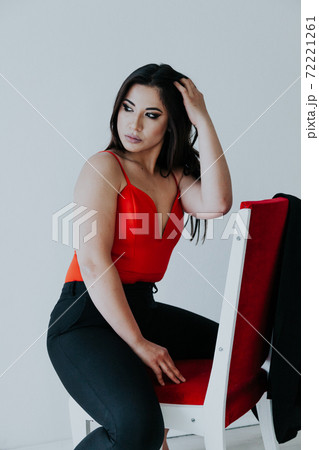 Beautiful fashionable oriental brunette woman in black orange dress Beautiful fashionable oriental brunette woman in black orange dress 72221261