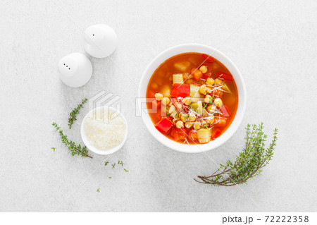 Tuscan tomato chickpea soup with various vegetables, thyme and parmesan cheese, top view 72222358