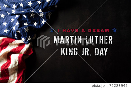 Happy Martin Luther King Day concept.  American flag againt black wooden background 72223945