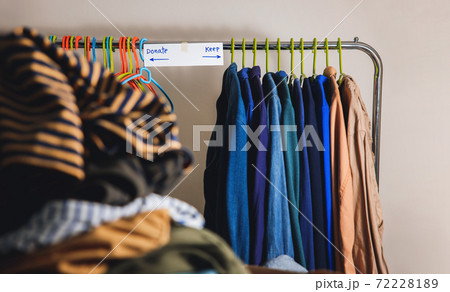 Donation Concept. Separated Used Old Clothes from Wardrobe Rack to Keep and Donate. Focus on Text 72228189