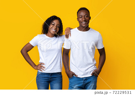 Black guy and his girlfriend posing on yellow 72229531
