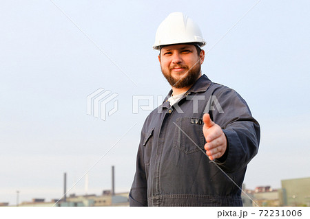 Portrait of male foreman with outstetched hands standing in construction site background. Portrait of male foreman with outstetched hands standing in construction site background. 72231006