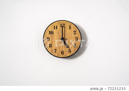 wood office wall clock with white dial on white background. wall clock on white background, top view. wood office wall clock with white dial on white background. wall clock on white background, top view. 72231233
