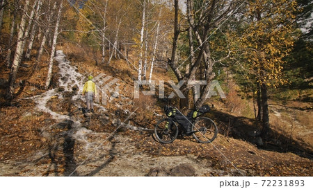 The man travel on mixed terrain cycle touring with bikepacking. The traveler journey with bicycle bags. Sport tourism bikepacking. The man travel on mixed terrain cycle touring with bikepacking. The traveler journey with bicycle bags. Sport tourism bikepacking. 72231893