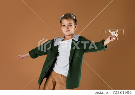 happy child boy playing with wooden toy airplane. dream happy child boy playing with wooden toy airplane. dream 72231909