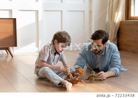 Caring dad play with little son with figures Caring dad play with little son with figures 72233438