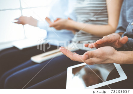 Business people clapping at meeting or conference, close-up of hands. Group of unknown businessmen and women in modern white office. Success teamwork, corporate coaching and applause concept 72233657