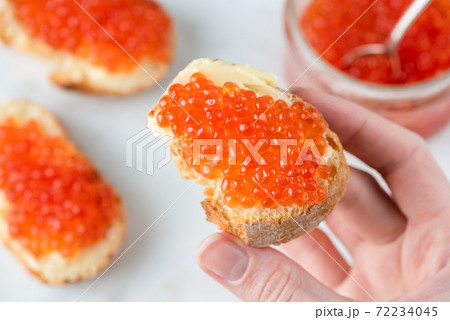 Red caviar and butter on slice of baguette bread Red caviar and butter on slice of baguette bread 72234045