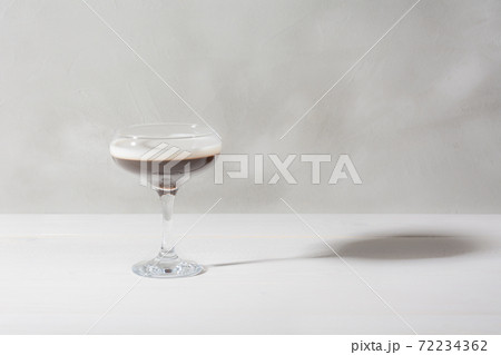 Jelly coffee with milk in a glass bowl in soft light. White background. Jelly coffee with milk in a glass bowl in soft light. White background. 72234362