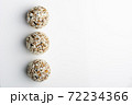 Diet vegetarian energy balls with nuts, dried fruit, chia, oats, cocoa, peanut butter and honey in coconut flakes. White background. 72234366