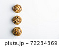 Diet vegetarian energy balls with nuts, chia, sunflower, dried fruit, oats, cocoa, peanut butter and honey. White background. 72234369