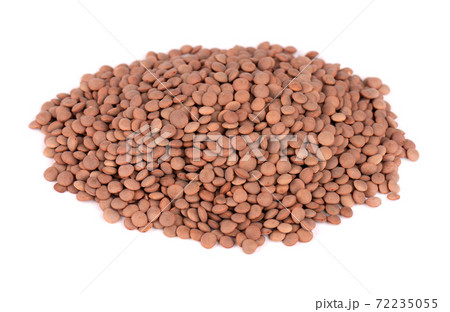 Brown lentils beans isolated on white background. Brown lentils beans isolated on white background. 72235055