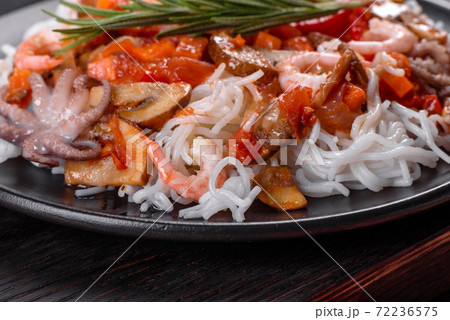 Tasty rice noodles with tomato, red pepper, mushrooms and seafood Tasty rice noodles with tomato, red pepper, mushrooms and seafood 72236575