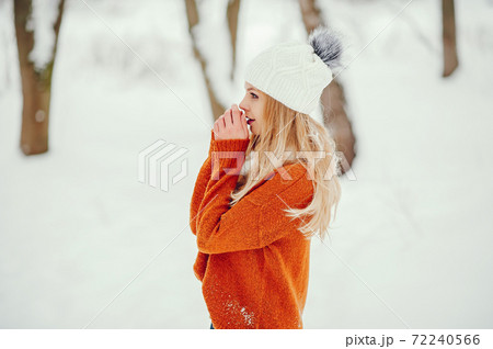 Beautiful girl in a cute orange sweater 72240566