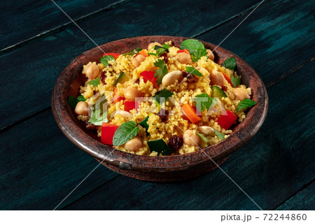 Couscous in the traditional tagine, with vegetables and herbs 72244860