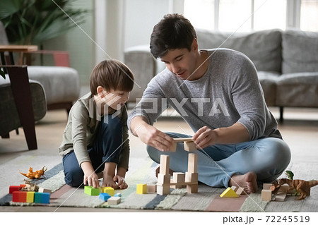 Caring millennial father playing with small son. Caring millennial father playing with small son. 72245519