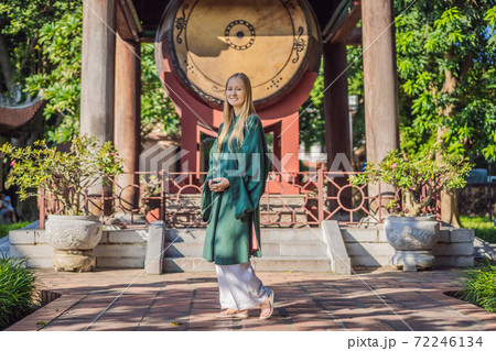 Woman tourist in national vietnamese dress in Temple of Literature in Hanoi in Southeast Asia, Vietnam. Vietnam reopens after coronavirus quarantine COVID 19 Woman tourist in national vietnamese dress in Temple of Literature in Hanoi in Southeast Asia, Vietnam. Vietnam reopens after coronavirus quarantine COVID 19 72246134