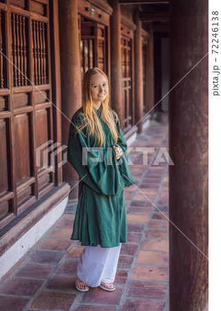 Woman tourist in national vietnamese dress in Temple of Literature in Hanoi in Southeast Asia, Vietnam. Vietnam reopens after coronavirus quarantine COVID 19 Woman tourist in national vietnamese dress in Temple of Literature in Hanoi in Southeast Asia, Vietnam. Vietnam reopens after coronavirus quarantine COVID 19 72246138