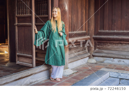 Woman tourist in national vietnamese dress in Temple of Literature in Hanoi in Southeast Asia, Vietnam. Vietnam reopens after coronavirus quarantine COVID 19 Woman tourist in national vietnamese dress in Temple of Literature in Hanoi in Southeast Asia, Vietnam. Vietnam reopens after coronavirus quarantine COVID 19 72246150
