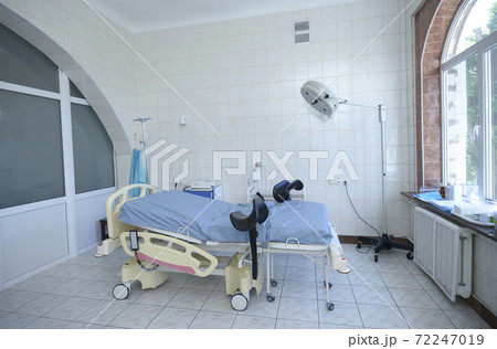 Delivery room of a maternity hospital, obstetric bed, lamp, medical equipment set Delivery room of a maternity hospital, obstetric bed, lamp, medical equipment set 72247019
