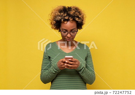 African woman holding in hands device chatting on web 72247752