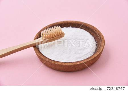 Bamboo toothbrush and baking soda on pink background. Zero waste concept Bamboo toothbrush and baking soda on pink background. Zero waste concept 72248767