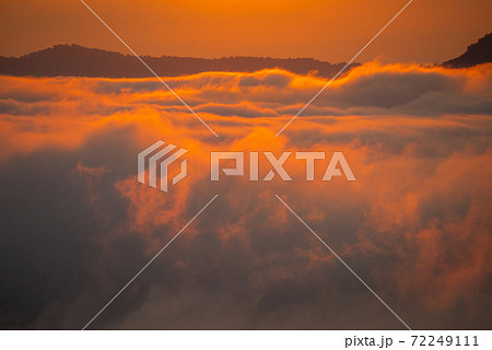 Beautiful dramatic sunset in the mountains. Landscape lot of fog Phu Thok Mountain at Chiang Khan ,Loei Province in Thailand. 72249111