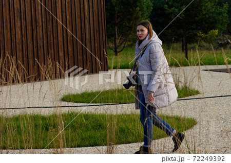 Woman photographer in nature park relaxing at master class. 72249392