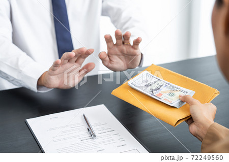 Businessman partner hand gesture rejecting refusing money, anticorruption concept. Businessman partner hand gesture rejecting refusing money, anticorruption concept. 72249560
