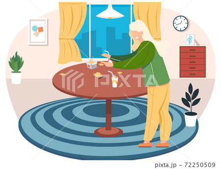 Young blonde woman is standing in cozy livingroom with a big round table at home in the evening Young blonde woman is standing in cozy livingroom with a big round table at home in the evening 72250509