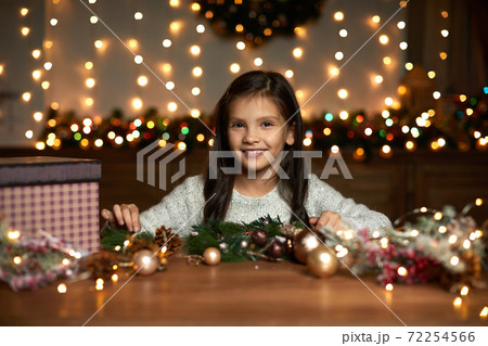 little child girl makes a handmade Christmas wreath little child girl makes a handmade Christmas wreath 72254566