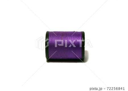 Purple thread in the black thread roll on white background. Prepare to use for sewing garment. Purple thread in the black thread roll on white background. Prepare to use for sewing garment. 72256841