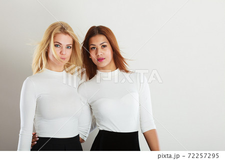 Two young friends together. 72257295
