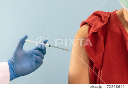 Doctor doing vaccine injection to woman in clinic Doctor doing vaccine injection to woman in clinic 72258642
