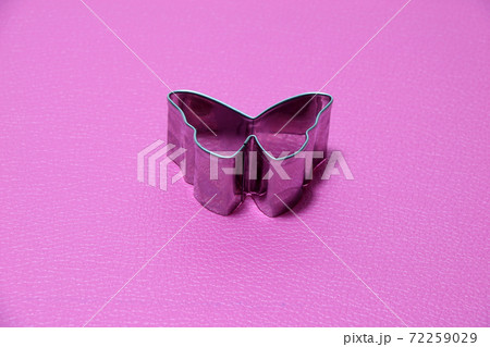 metal dough press mold Butterfly shape on pink floor. 72259029