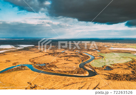 Europe. Aerial View Of Dry Grass And Partly Frozen Curved River Landscape In Autumn Day. High Attitude View. Marsh Bog. Drone View. Bird's Eye View Europe. Aerial View Of Dry Grass And Partly Frozen Curved River Landscape In Autumn Day. High Attitude View. Marsh Bog. Drone View. Bird's Eye View 72263526
