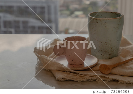 Blue and pink ceramics mugs handmade with wooden spoon. Blue and pink ceramics mugs handmade with wooden spoon. 72264503