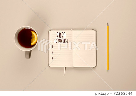 2021 To do list. Tea cup and modern notebook with to do list toned in Champagne color 2021 To do list. Tea cup and modern notebook with to do list toned in Champagne color 72265544