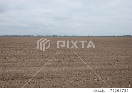 Beautiful sky over a plowed agricultural field. Agro-industrial landscape. A plowed farm field. Cultivated soil during the day. Beautiful sky over a plowed agricultural field. Agro-industrial landscape. A plowed farm field. Cultivated soil during the day. 72265735