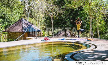 Asian women relax in the holiday. Play if yoga in the Pool Hot Spring, Relaxing in a natural hot springs.Yoga posture exercise. Asian women relax in the holiday. Play if yoga in the Pool Hot Spring, Relaxing in a natural hot springs.Yoga posture exercise. 72266946