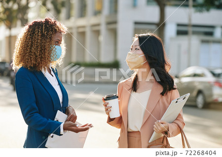 Businesswomen discussing project Businesswomen discussing project 72268404