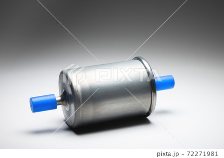 New fuel filter for gasoline internal combustion engine with blue caps on a gray background. New spare parts New fuel filter for gasoline internal combustion engine with blue caps on a gray background. New spare parts 72271981